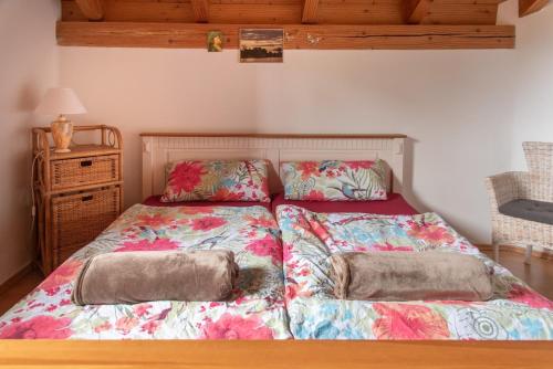a bed with two pillows on it in a bedroom at Idyll in Ammerseenähe mit Blick ins Grüne in Windach