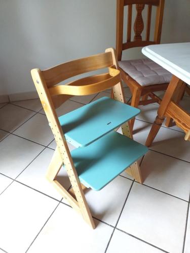 a wooden chair sitting next to a table at Idyll in Ammerseenähe mit Blick ins Grüne in Windach