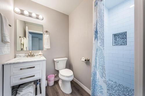 a bathroom with a toilet and a sink and a shower at 2 Bedroom Beachside Suite in Clearwater Beach