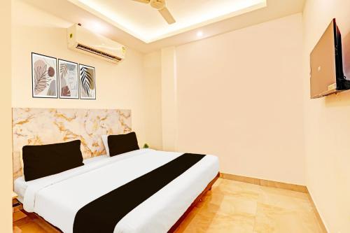 a bedroom with a large bed and a flat screen tv at The Krishna's Bliss in Ghaziabad
