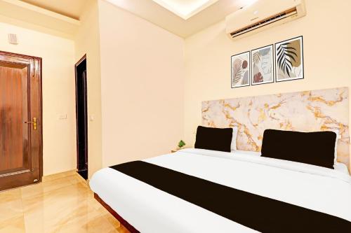 a bedroom with a large white bed in a room at The Krishna's Bliss in Ghaziabad