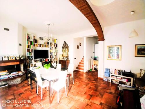 a dining room with a table and chairs in a room at Cozy Valeria's Room in Camaiore