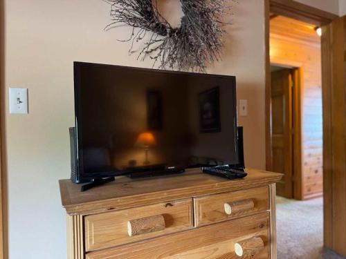 a flat screen tv sitting on top of a wooden dresser at Island Cove #9 - On Minocqua Lake in Minocqua