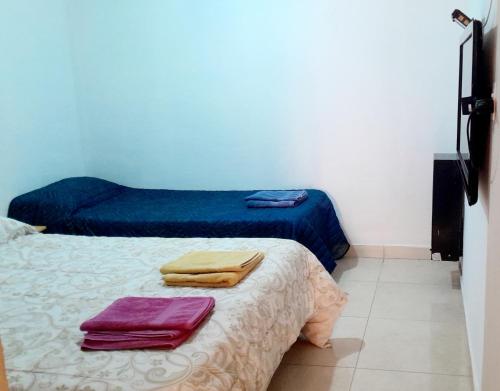 a room with a bed with two towels on it at Piedrabuena Yenua1 in Comandante Luis Piedra Buena
