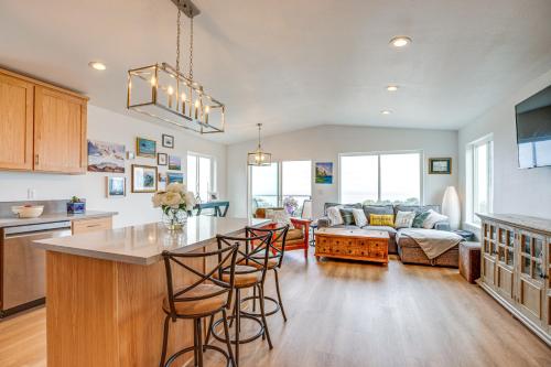a kitchen and living room with a bar and chairs at Walk to Beach WFH-Friendly Retreat in Tillamook! in Tillamook