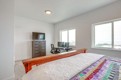 a bedroom with a bed and a desk with a computer at Walk to Beach WFH-Friendly Retreat in Tillamook! in Tillamook