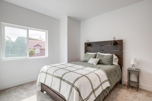 a white bedroom with a bed and a window at Walk to Beach WFH-Friendly Retreat in Tillamook! in Tillamook