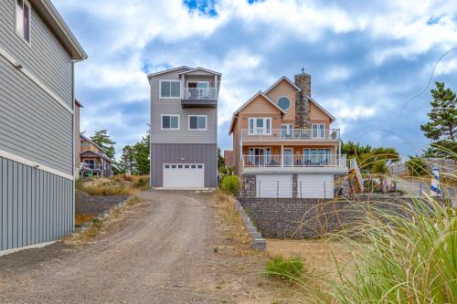 a house on a dirt road next to a house at Walk to Beach WFH-Friendly Retreat in Tillamook! in Tillamook