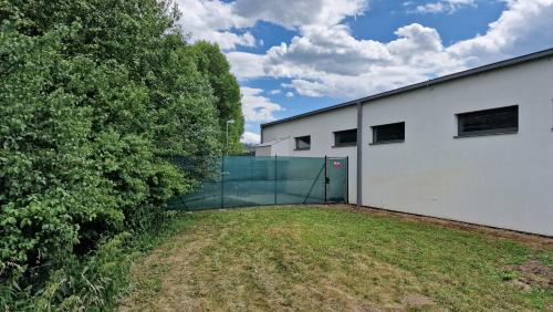 a white building with a gate in a yard at Hollywood Dream in Knínice u Boskovic