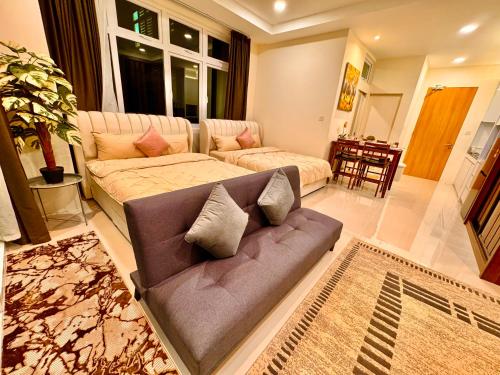 a living room with a couch at Kuching 4Pax Riverine High Floor Resort Stay Kuching Waterfront View from Balcony in Kuching
