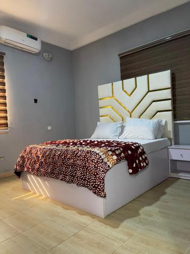 a bedroom with a large bed in a room at Ungess Global Ventures in Iju Junction