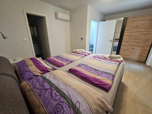 a group of three beds in a room at Villa Carpe Diem in Vantačići