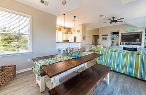 a living room with a table and a couch at Family Tradition in Duck