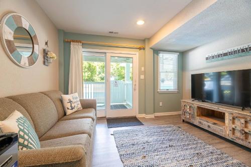 a living room with a couch and a flat screen tv at Family Tradition in Duck