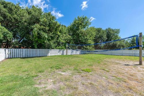 a volleyball net in a yard with a fence at Family Tradition in Duck