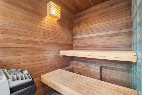 a sauna with wooden walls and a bench in it at 0287-Romo-Sonder-Frankel-28 in Havneby