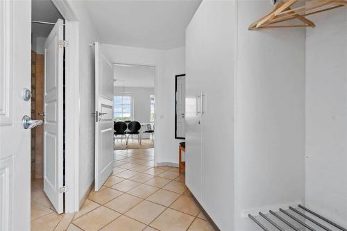 a hallway with white walls and a tile floor at 0287-Romo-Sonder-Frankel-28 in Havneby