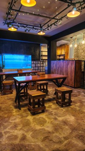 a ping pong table and benches in a room at Carls' Corner in Kandy