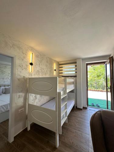 a bedroom with two bunk beds and a window at Treva Hotel & Apartaments in Prizren