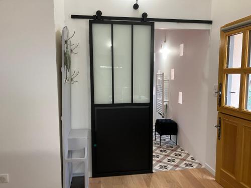 a black door in a room with a chair at Le pigeonnier in Nîmes