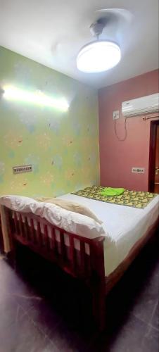 a bed in a room with a fishtank wall at Sainathan Residency in Puducherry