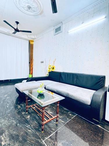 a living room with a couch and a coffee table at Sainathan Residency in Puducherry