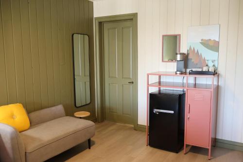 a living room with a couch and a chair at Hôtel au Petit Berger in La Malbaie
