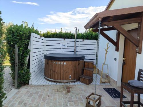 a hot tub in a backyard with a white fence at Il Giardino Di Epicuro in Rocca San Giovanni