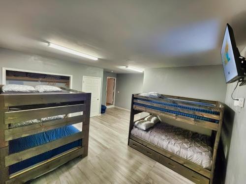two bunk beds in a room with a bedroom at Percy Priest Lake2 Quiet Family Home in La Vergne