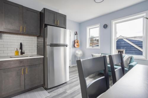 a kitchen with a refrigerator and a table and chairs at Two BR in Lodi Pet Friendly with Laundry & Parking in Lodi