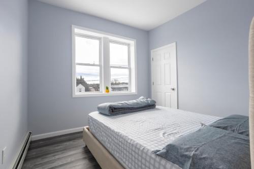 a white bedroom with a bed and a window at Two BR in Lodi Pet Friendly with Laundry & Parking in Lodi