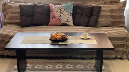 a coffee table with a bowl of fruit on top of a couch at Ski Lift Studio 531 in Bansko