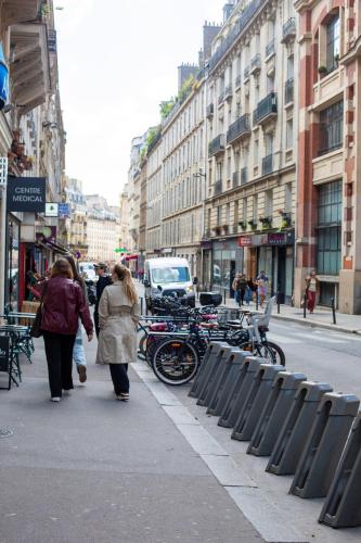 two women walking down a sidewalk in a city at Altona in Paris