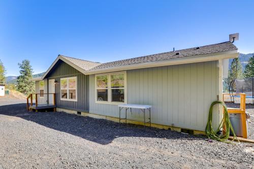 a small green house with a gravel driveway at Mtn-View Gem with Outdoor Entertainment in Ahsahka! 