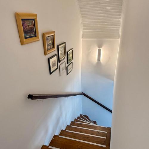 a staircase in a house with pictures on the wall at Pokito House on the Hill in Sremski Karlovci