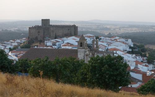 an old castle sits on top of a city at Casa Rural La Fuente in Segura de León