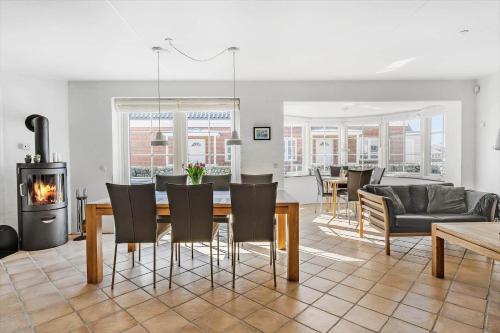 a living room with a table and chairs and a fireplace at 0381-Romo-Sonder-Frankel-44 in Havneby