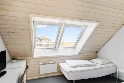a small room with a bed and a window at 0381-Romo-Sonder-Frankel-44 in Havneby