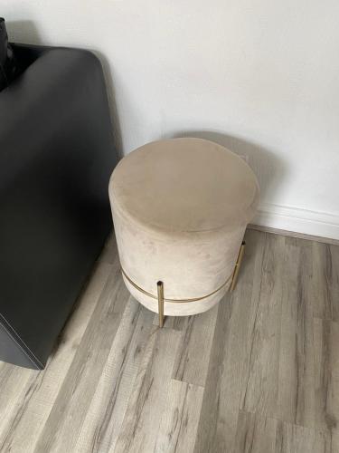 a stool sitting in a room next to a wall at Spacious & Comfortable 3 Bedroom House - FREE WiFi & FREE Parking in Killingbeck