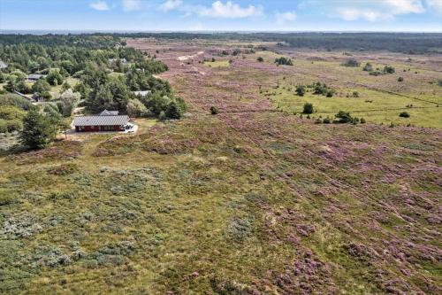 an aerial view of a house on top of a field at 0180-Romo-Ejnar-Mikkelsensvej-8 in Lakolk