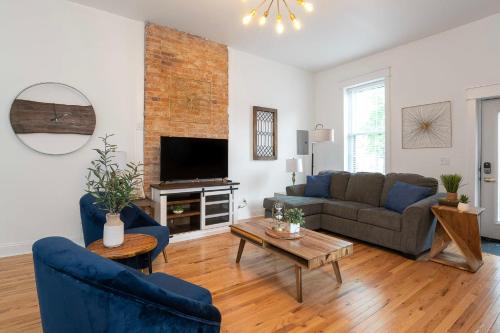 a living room with a couch and a tv at Condo Combo on Lee - 2 in 1 in Covington