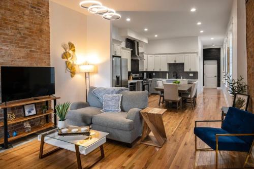 a living room with a couch and a tv at Condo Combo on Lee - 2 in 1 in Covington