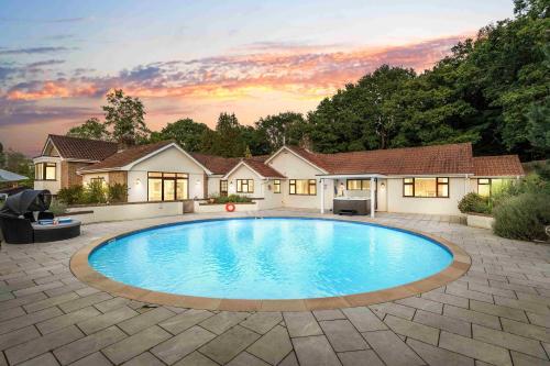 a swimming pool in the yard of a house at Churchill Country Retreat By My Getaways in Lewes