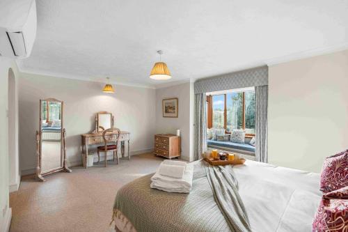 a bedroom with a bed and a desk and a table at Churchill Country Retreat By My Getaways in Lewes