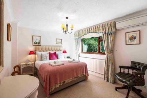 a bedroom with a bed and a chair and a window at Churchill Country Retreat By My Getaways in Lewes