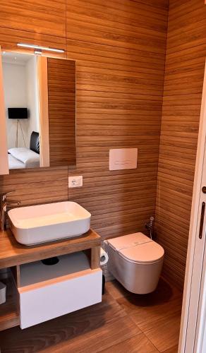 a bathroom with a sink and a toilet and a mirror at Marlou Health&Fit Club in Buccino