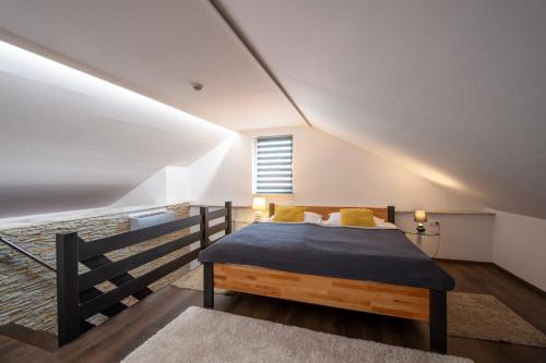 a bedroom with a bed with a blue blanket on it at Apartmány Ztracená in Roudnice nad Labem