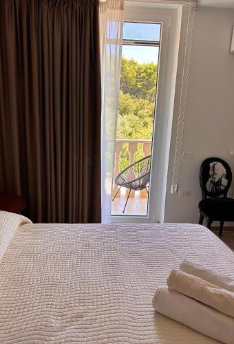 a bedroom with a bed and a view of a balcony at Marlou Health&Fit Club in Buccino