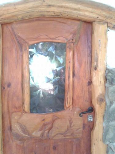 a wooden door with a bag of garbage at Del Viejo Camino in El Bolsón
