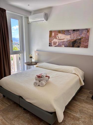 a bedroom with a bed with towels on it at Marlou Health&Fit Club in Buccino